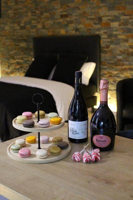 Bouteilles de vin et plateau de macarons - L'Alchimie