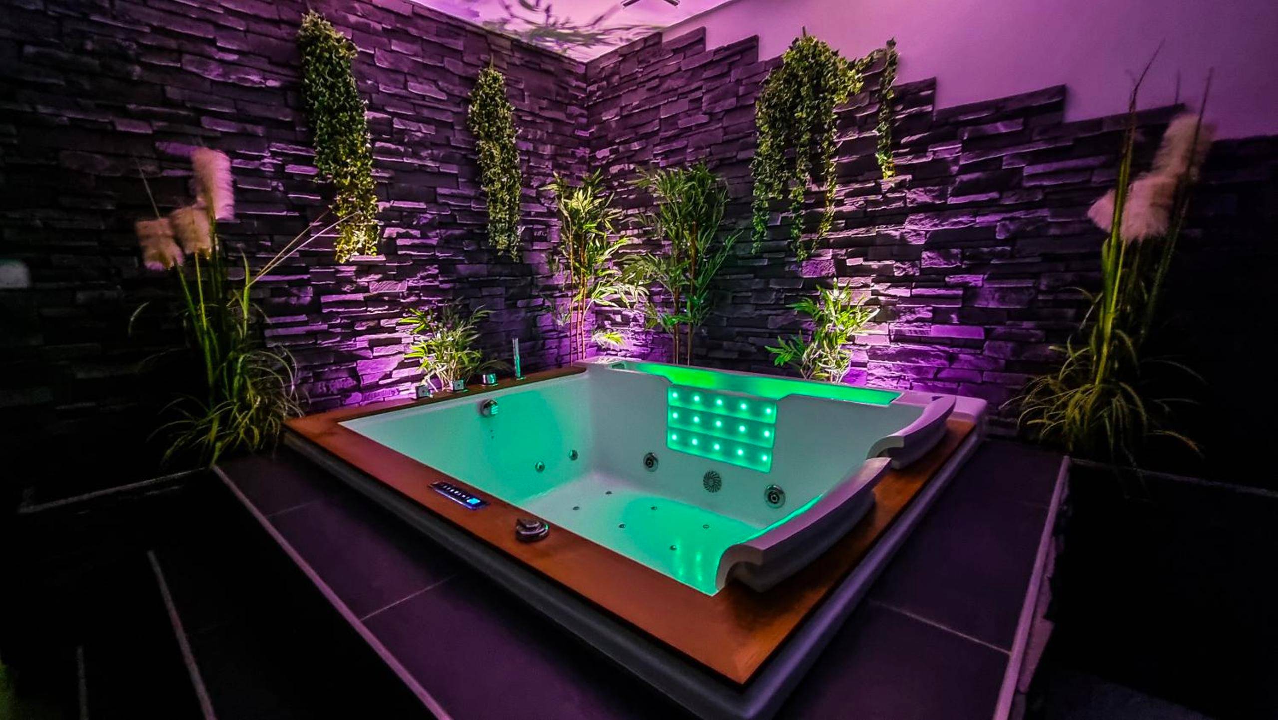 Jacuzzi privatif avec éclairage vert et violet - Love Room Gray - Appart' spa privatif Gray