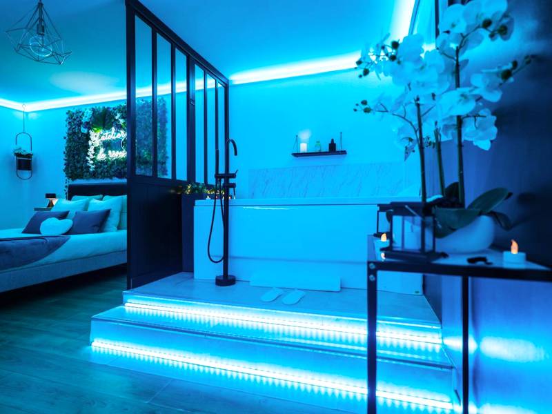 Espace spa et chambre avec éclairage néon bleu - L'Atelier de rêves