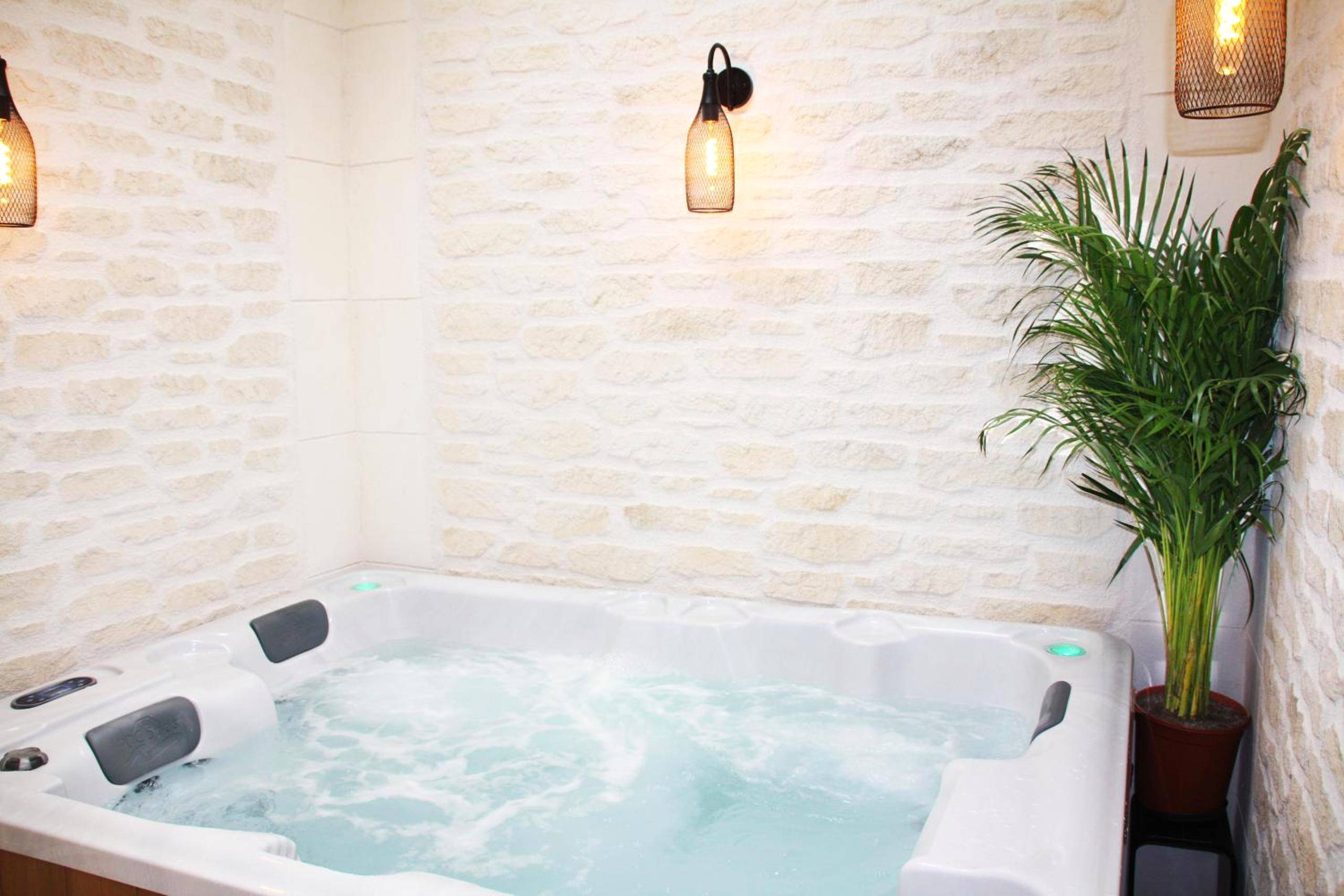 Jacuzzi privatif sous luminaires design - Love Room Épernay - L'Atelier - Gîte & Spa
