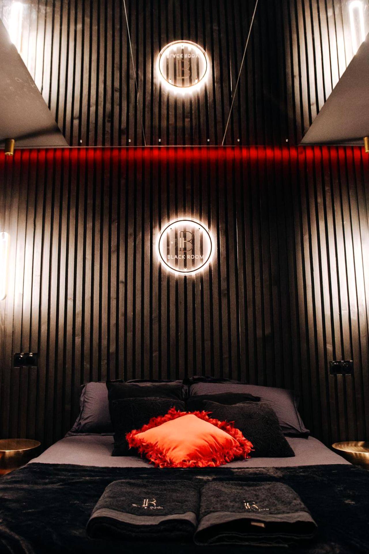 Lit double avec coussin rouge et miroir au plafond - BlackRoom Suite de Luxe 50 Nuances de grey