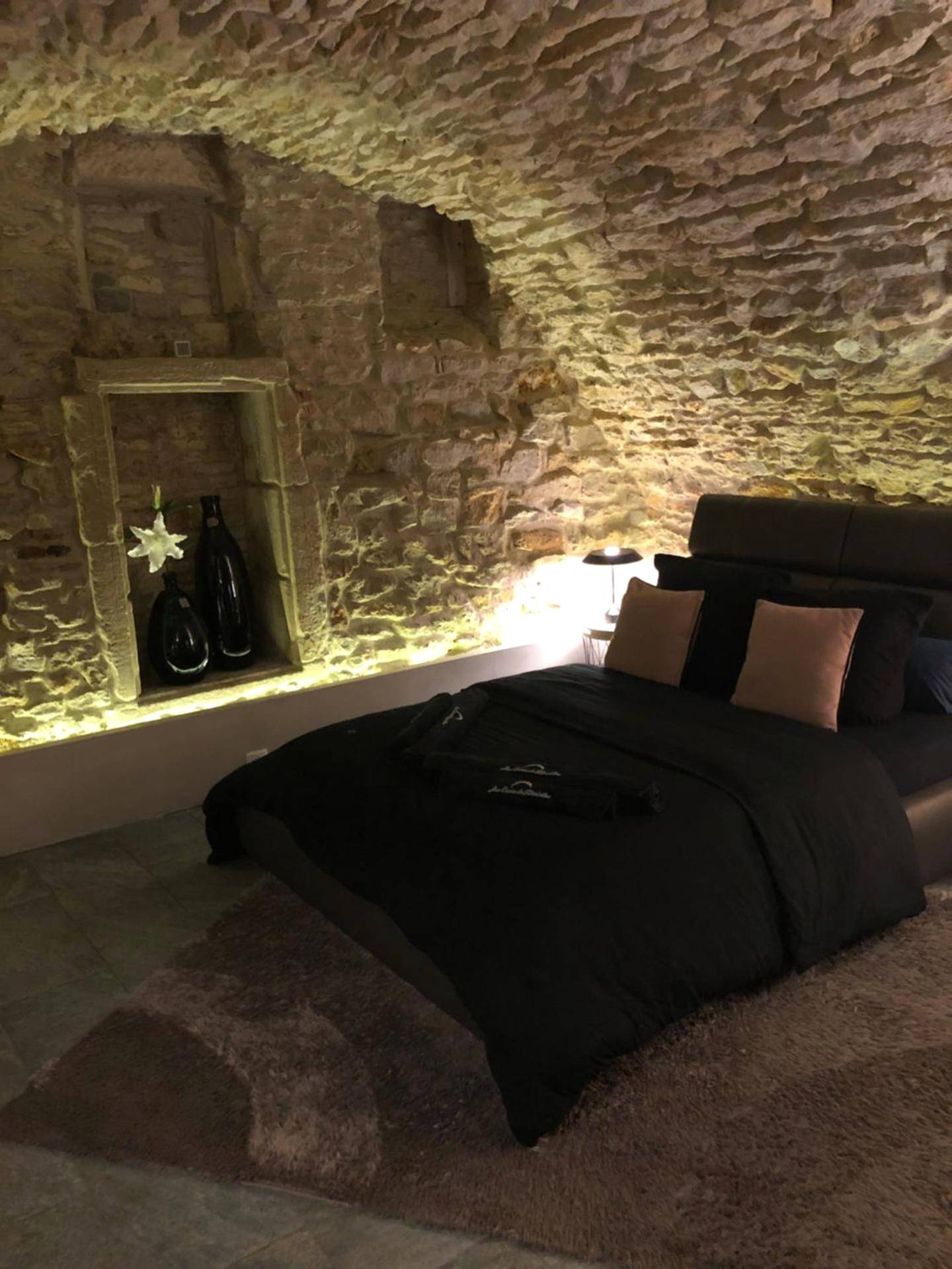 Lit double dans chambre voûtée en pierre - jaccuzi & spa des caves Stanislas