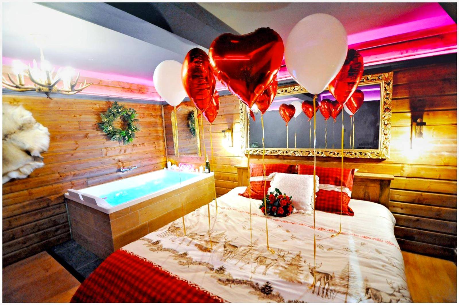 Lit romantique décoré de ballons et fleurs - Le Chalet romantique, SPA XXL, Écran cinéma, Lit king size, cascade d'eau