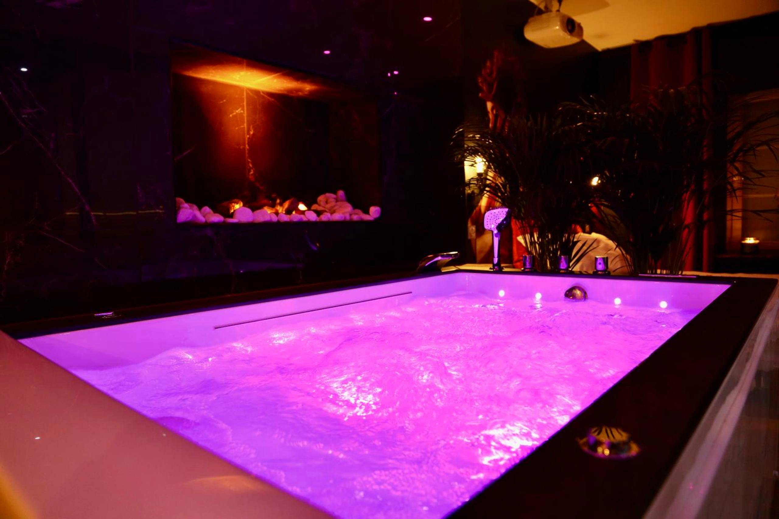 Baignoire balnéo lumineuse et foyer d'ambiance - love room gold - les delices rooms