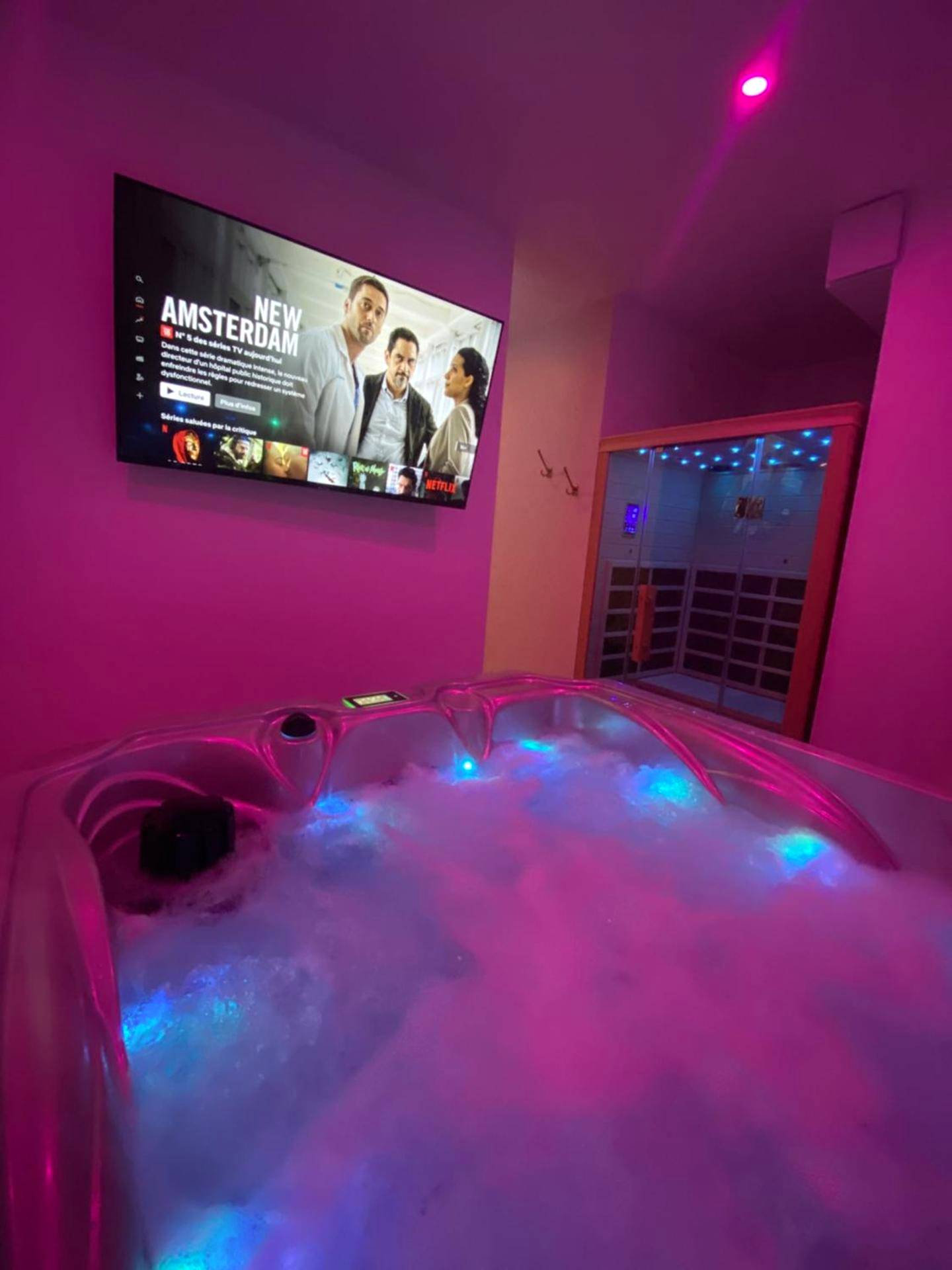Jacuzzi avec mousse sous écran géant - Love Room Rouen - Eaux Spa