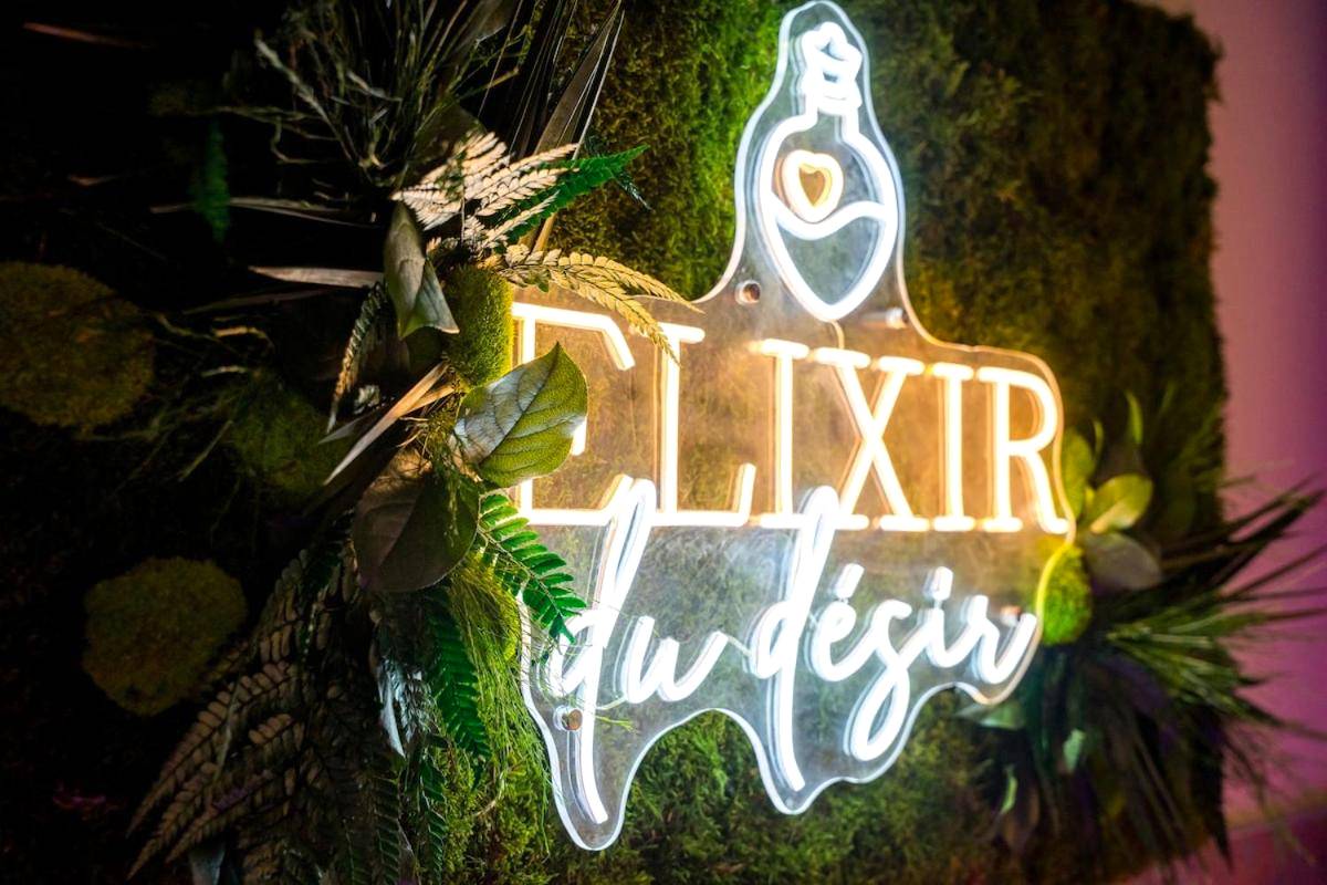 Enseigne lumineuse sur mur végétal - Love Room Elixir du désir