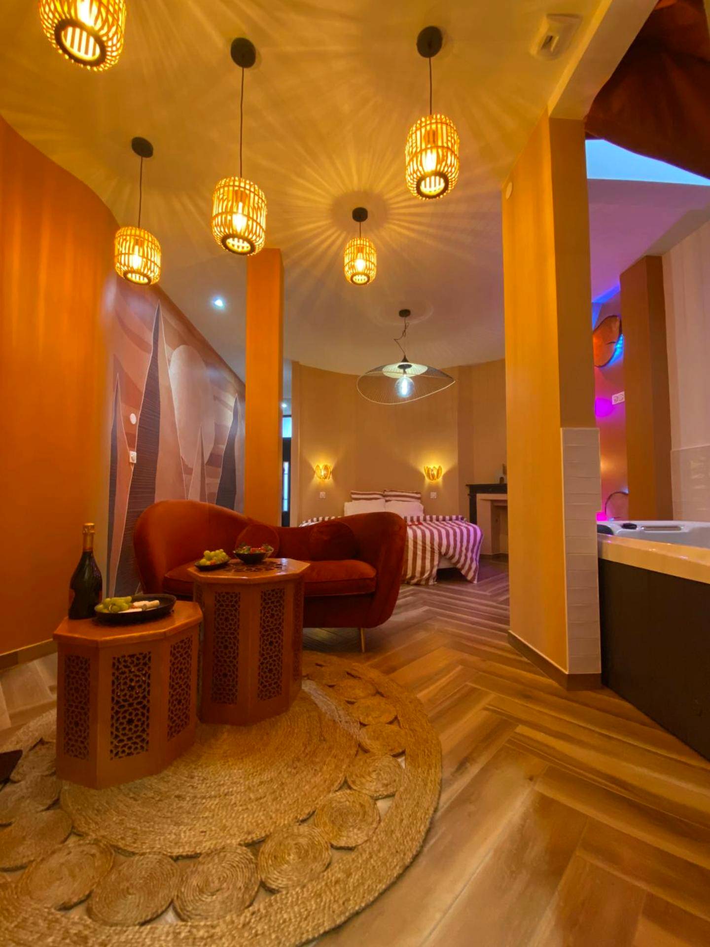 Salon chaleureux avec canapé en velours rouge - Love Room Amiens - L'enveloppe Romantique