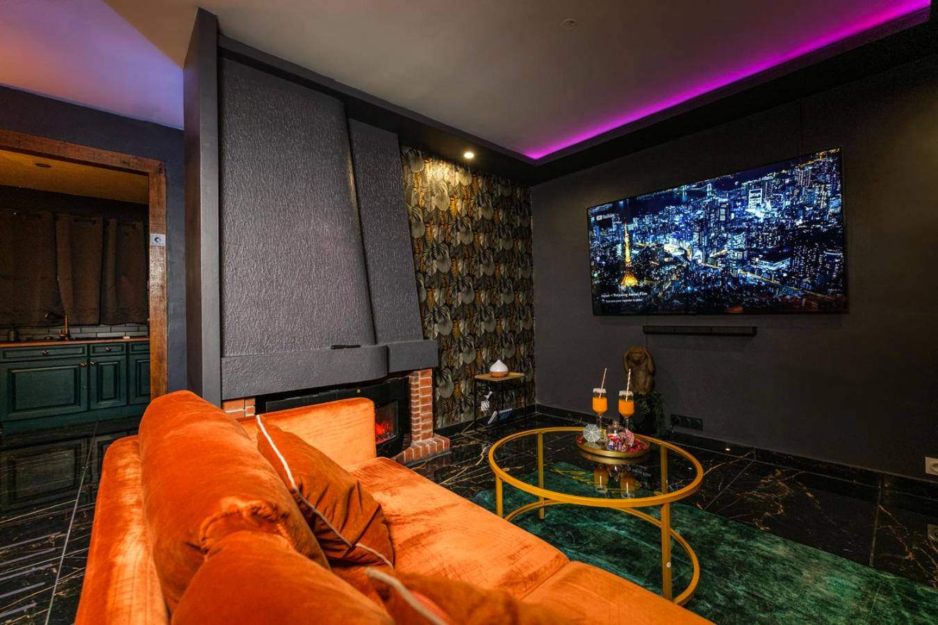 Espace détente avec grand écran et cheminée - L escale Jacuzzi et Sauna