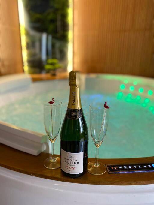 Bouteille de champagne et flûtes devant jacuzzi - Love Room Mulhouse - Esprit BALI ....LOVE SPA, Sauna de luxe à Mulhouse