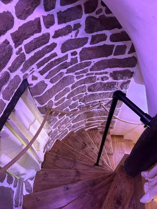 Escalier en colimaçon en bois et mur de pierre - L'Etreinte, gîte de charme avec jacuzzi intérieur et sauna