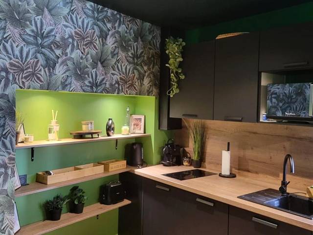 Cuisine équipée moderne aux tons noir et bois - Évasion Sauvage Love Room