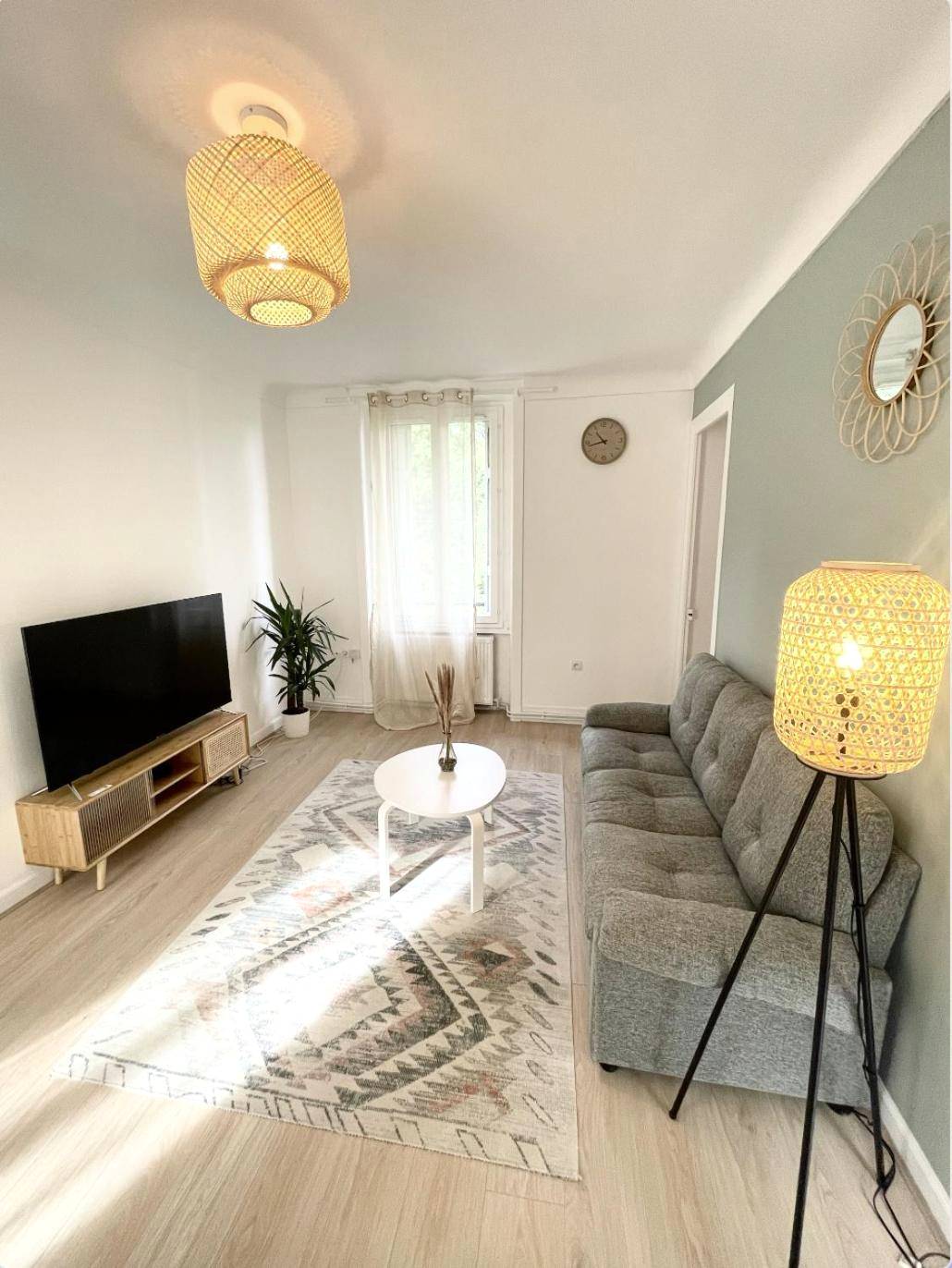 Salon lumineux avec canapé gris et télévision - Le Golf Sauna - Cosy & SPA - 2 chambres - 4 pers