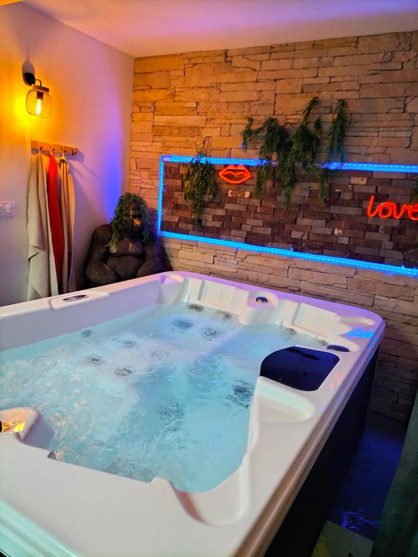 Jacuzzi privatif avec néons et mur de pierre - Love room, L'idyle loft érotique détente