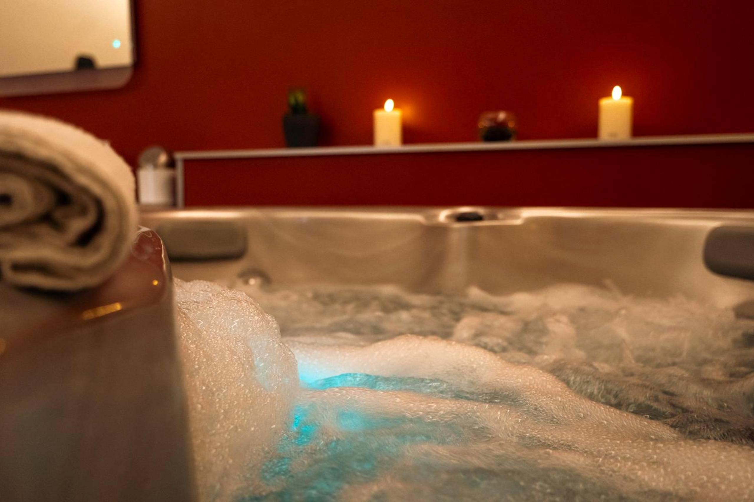 Gros plan sur bulles de jacuzzi et bougies - Ignite Love Room