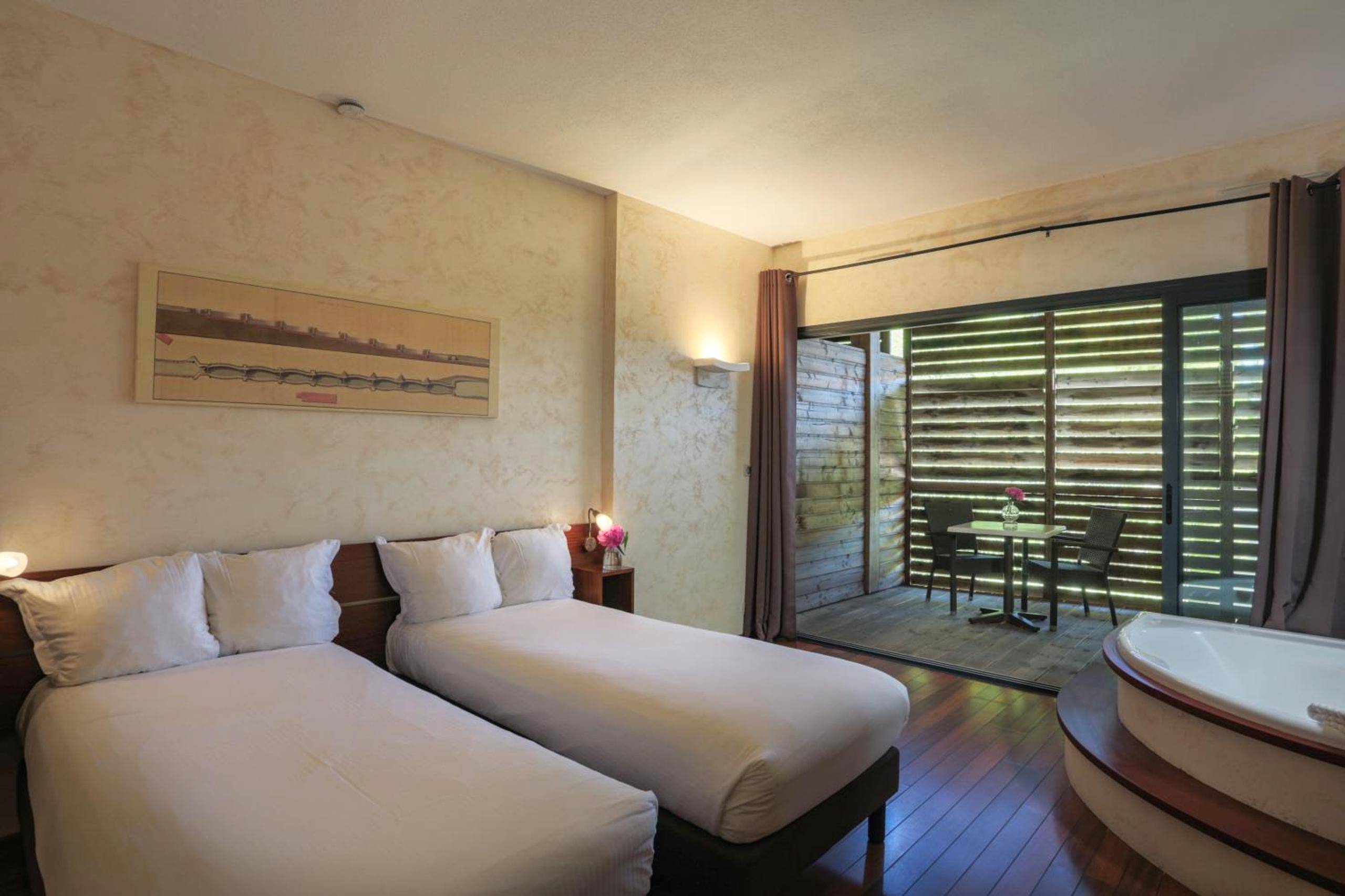 Lits jumeaux et jacuzzi dans chambre spacieuse - Ile du Gua Suites