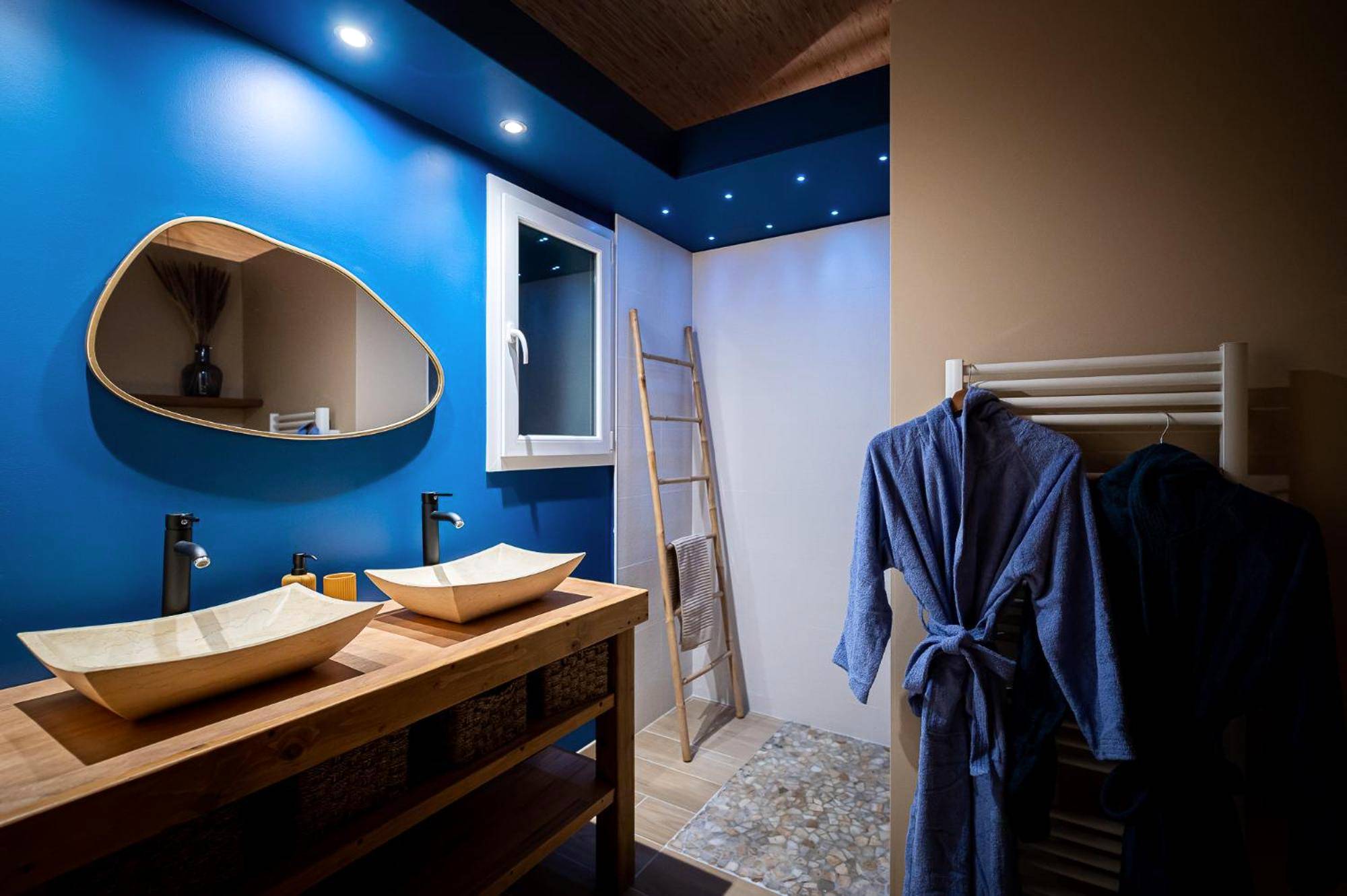 Salle de bain moderne avec double vasque et peignoirs - Logement romantique avec jacuzzi privatif