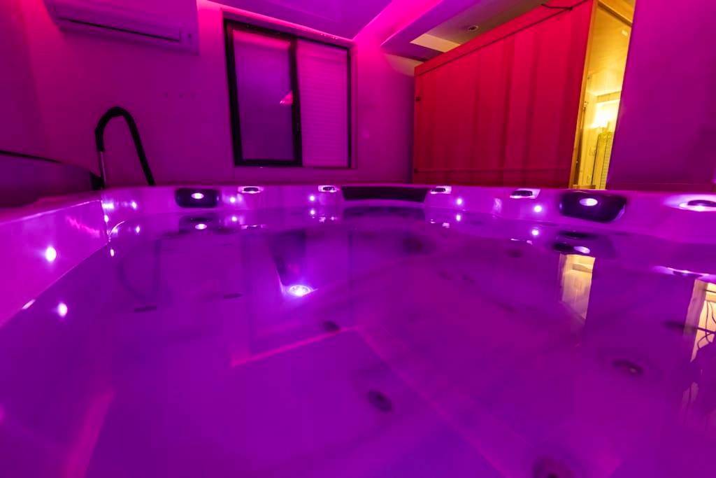 Jacuzzi privatif avec éclairage LED rose - Love Room Marseille - Laissepassetemps
