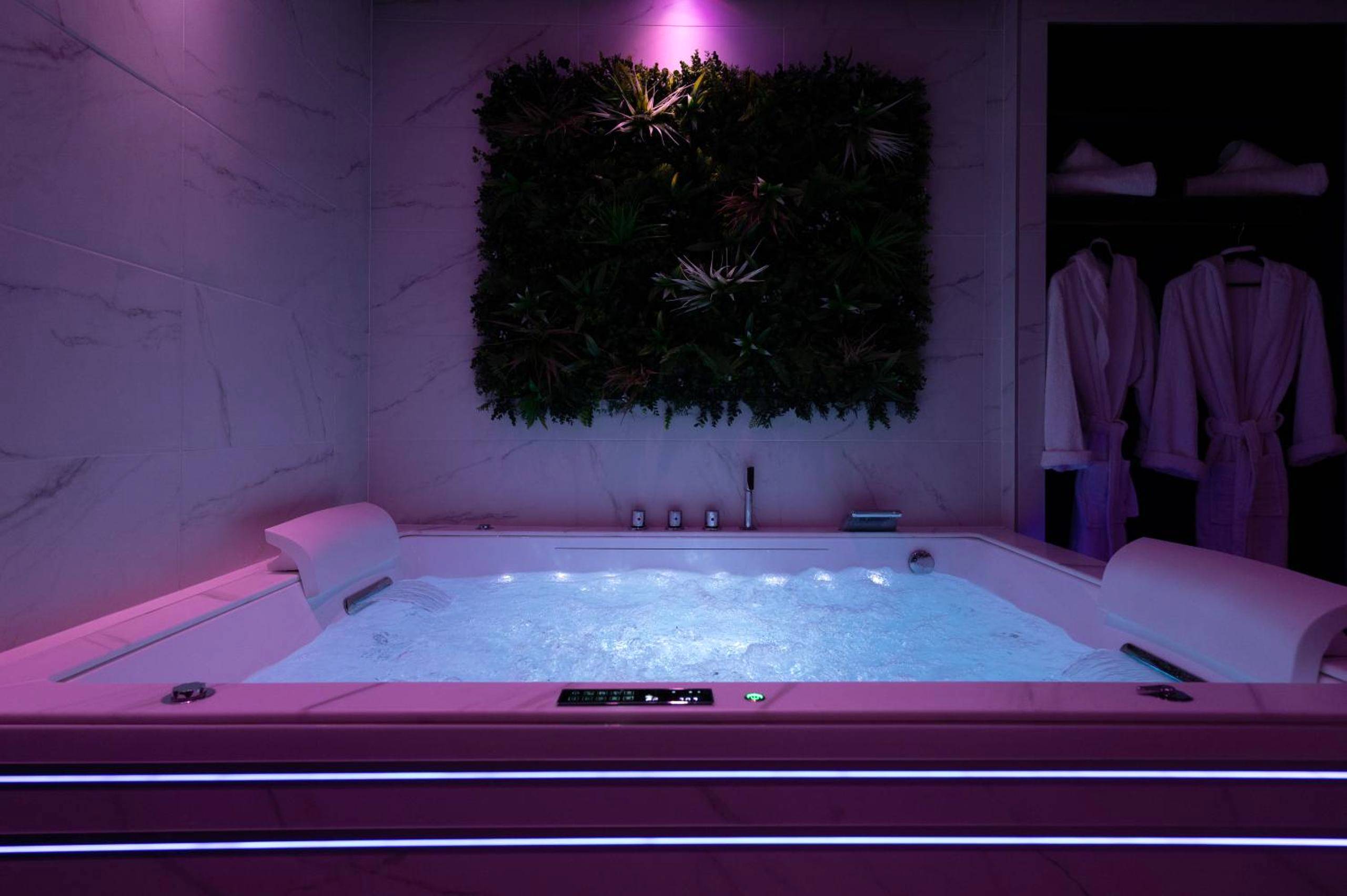 Jacuzzi privatif avec mur végétal et peignoirs - LaPerleNoire Love Room XXL