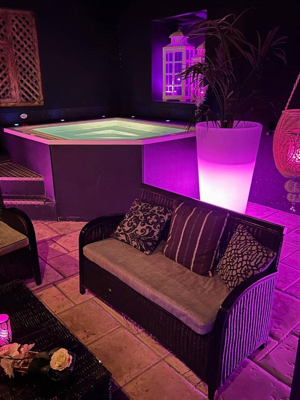 Jacuzzi privatif et salon avec éclairage rose - Nuit romantique au Lounge et Spa