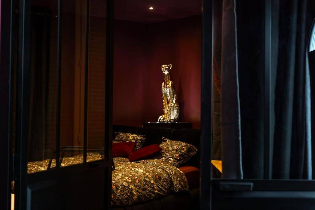 Chambre avec lit double et statue de guépard - Love Room Lorient - LOVE ROOM LORIENT LoveLoft L'Escapade Romantique