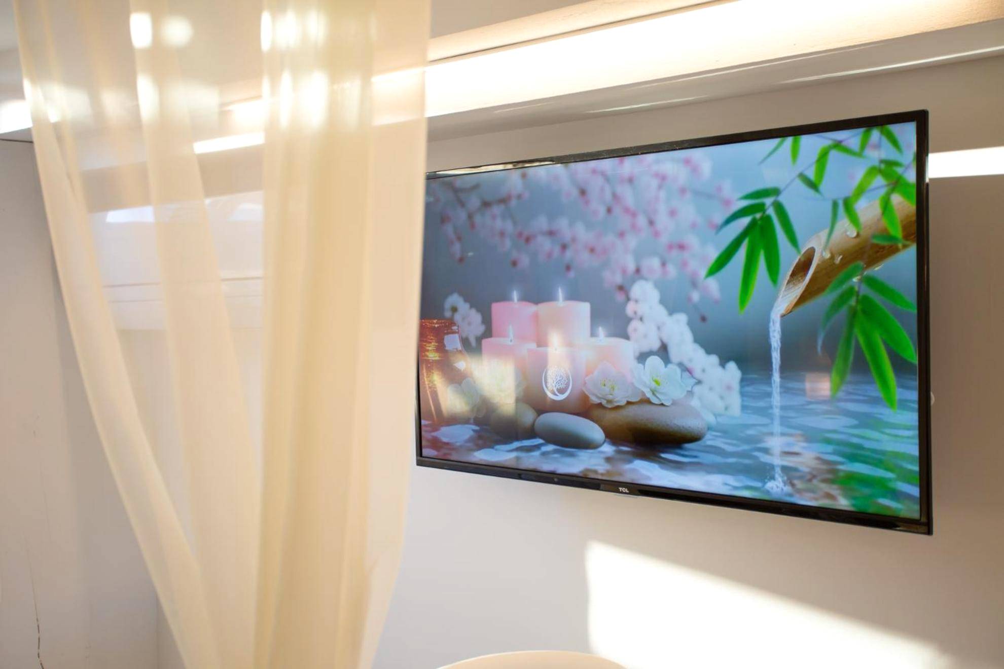Télévision murale avec image relaxante - Lovina chambre de charme avec jacuzzi