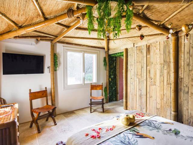 Espace nuit avec télévision et décor exotique - Gîtes Mas des rochers - Case bambou avec Spa