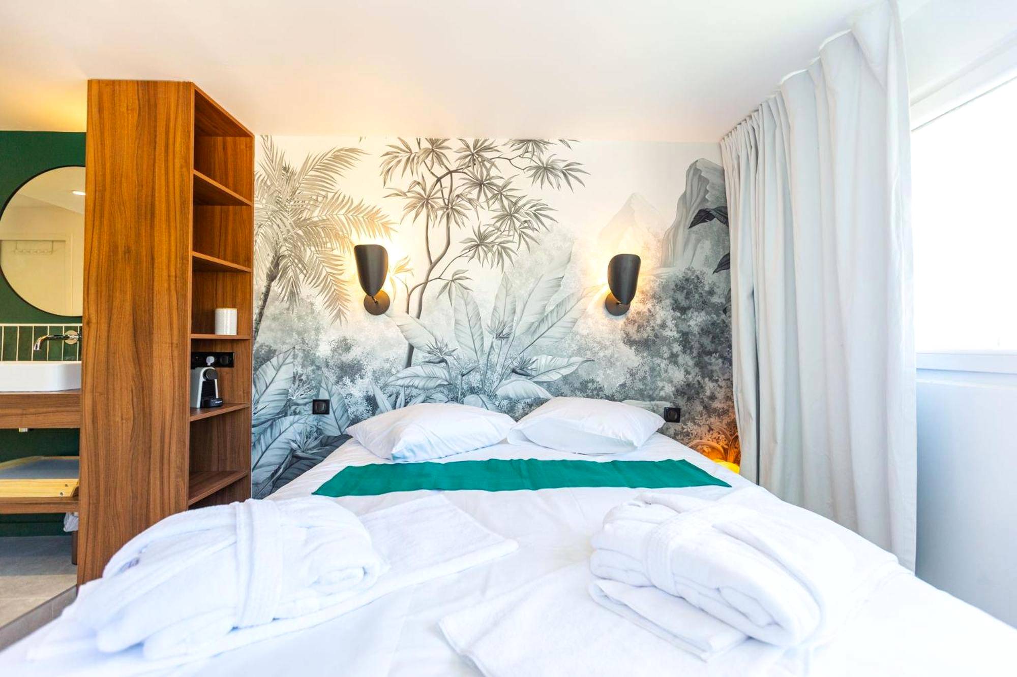 Chambre avec fresque tropicale et peignoirs - Love Room du Mont d'Or - Baignoire SPA - Minibar offert
