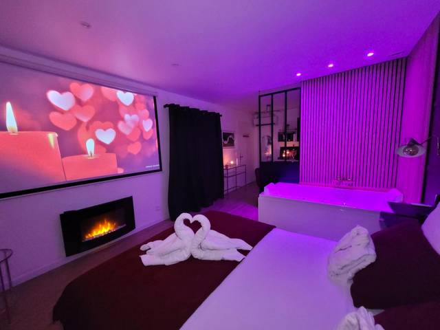 Suite avec écran géant, cheminée et jacuzzi - Nuit d'évasion love room avec baignoire balnéothérapie