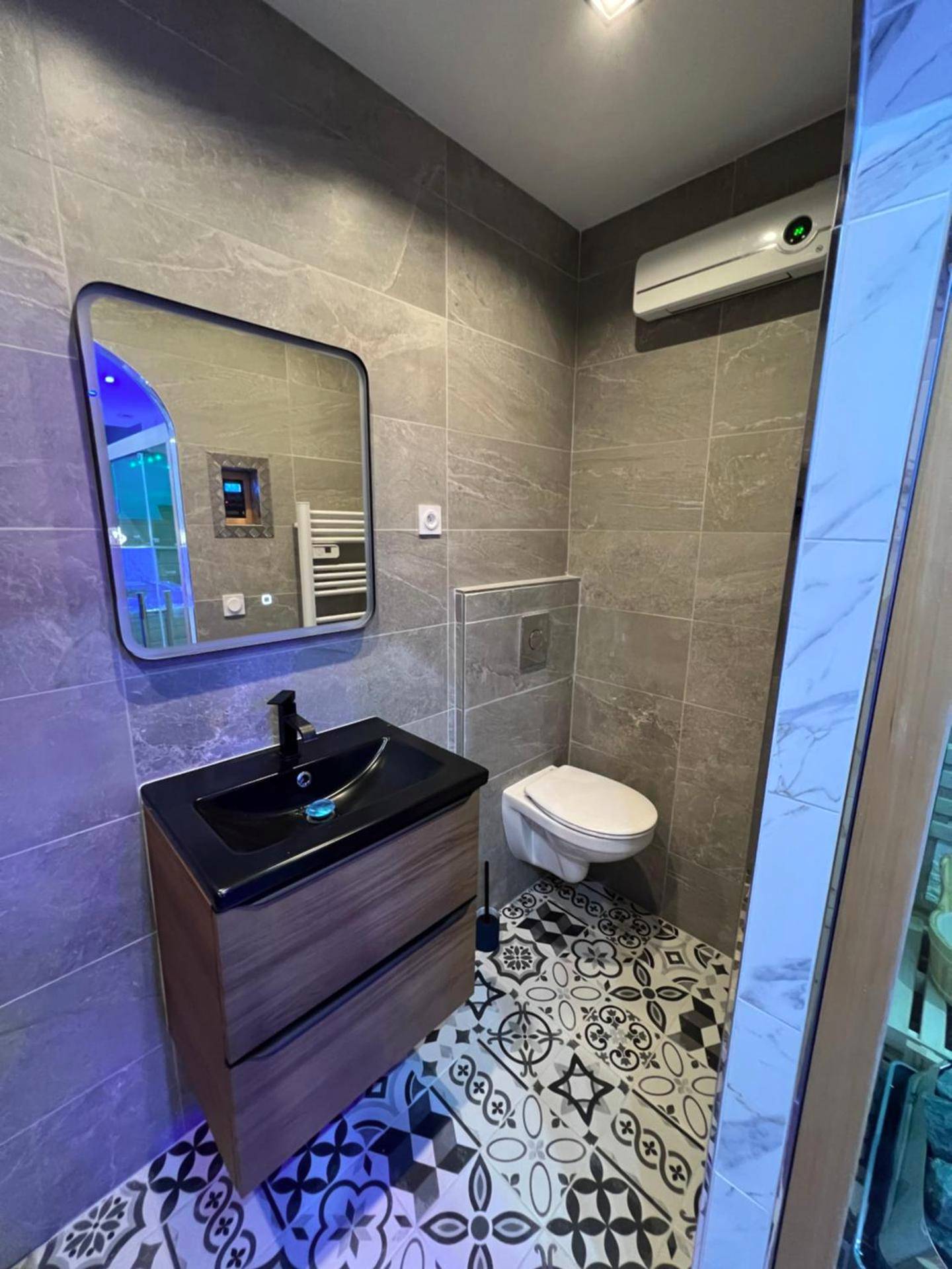 Salle d'eau moderne avec carrelage à motifs - La nuit de rêve Spa privatif Jaccuzi Sauna suite 1