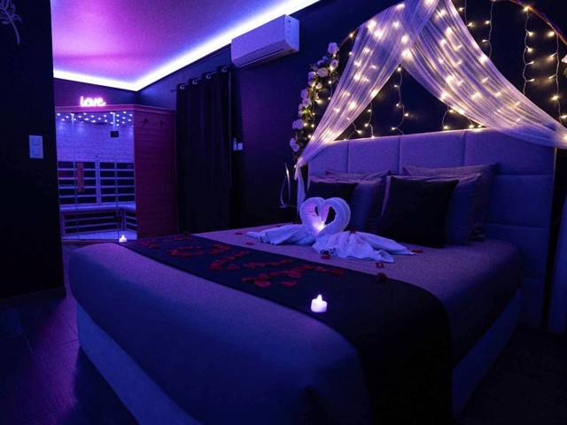Lit double avec cygnes en serviette et pétales - LA NUIT DES SECRETS Love Room 4 étoiles avec Jacuzzi et Sauna
