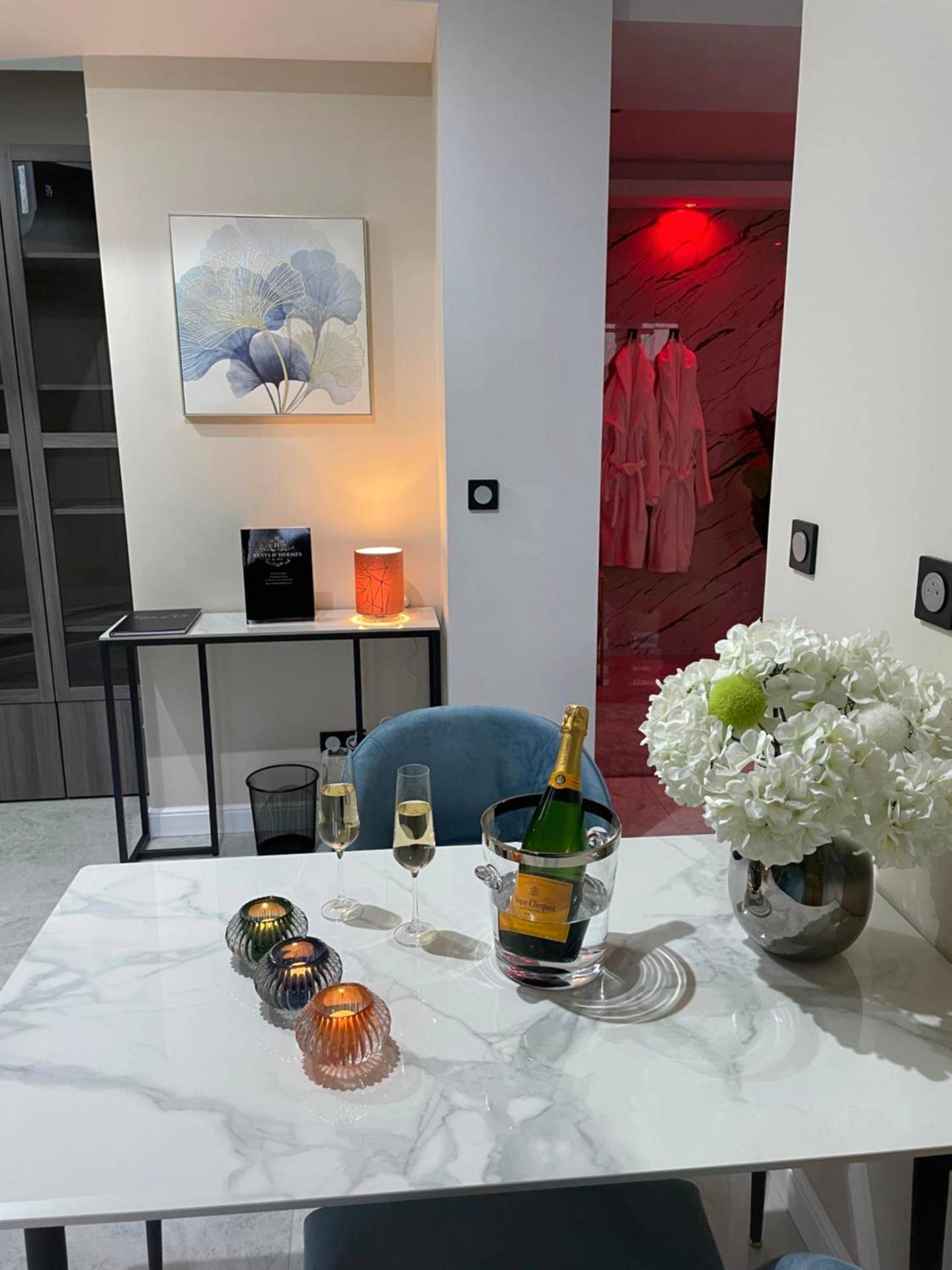 Table dressée avec champagne et fleurs blanches - NUITS D'HERMES & Spa