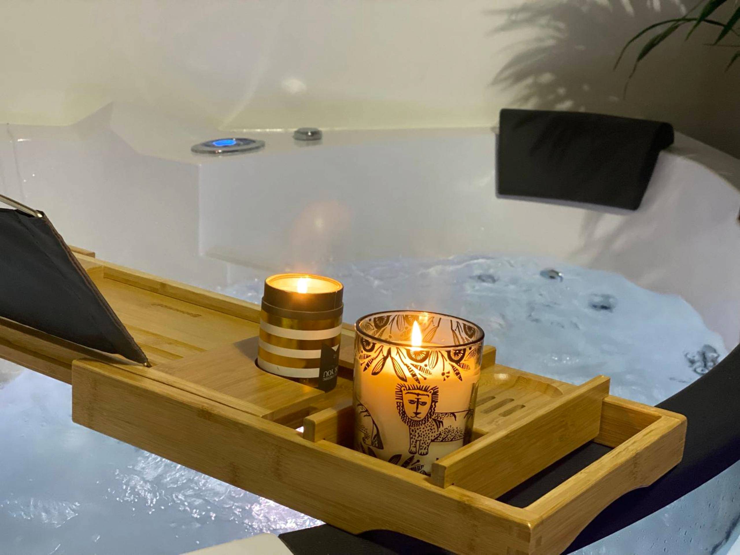 Bougies allumées sur un plateau de baignoire - L'Oasis Angevine - Balneo, Sauna, Home Cinema & Parking