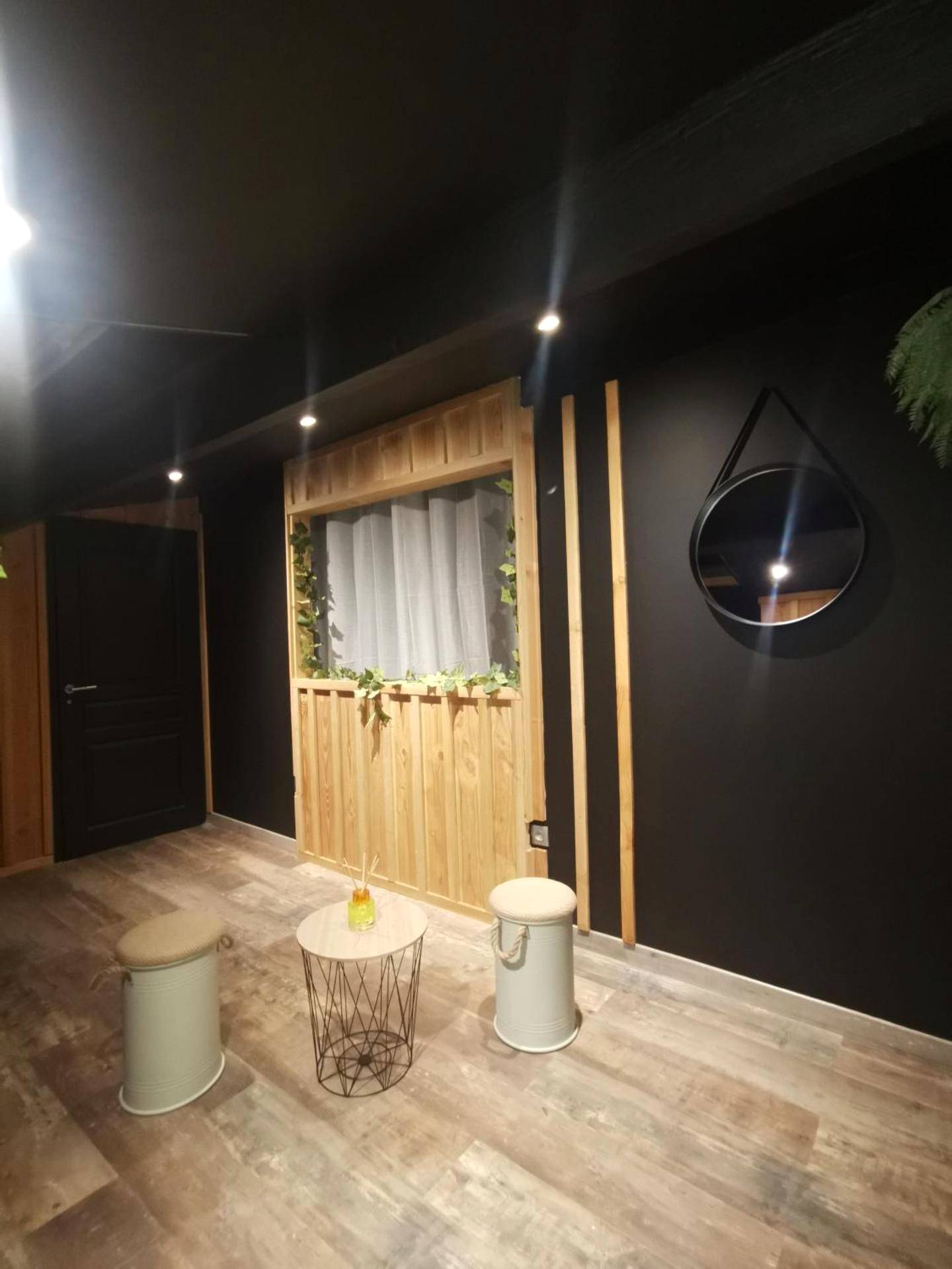 Espace détente avec tabourets et miroir rond - love room paradix