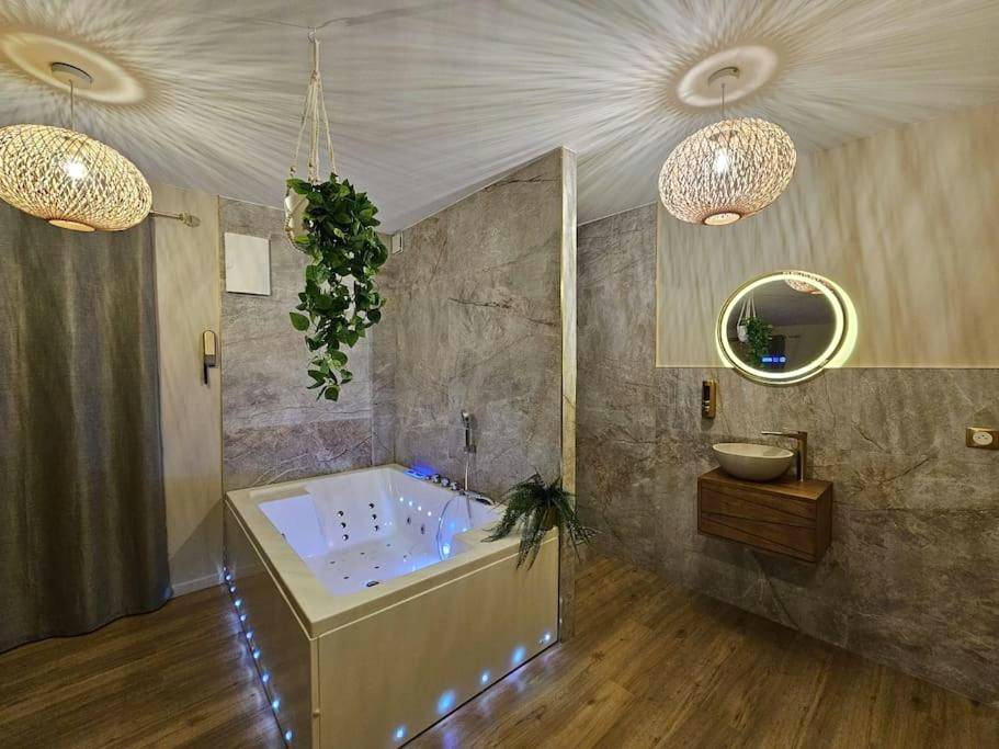 Baignoire balnéo et vasque sur meuble bois - Love Room Oyonnax - La Parenthèse - Votre Cocon au Centre d'Oyonnax