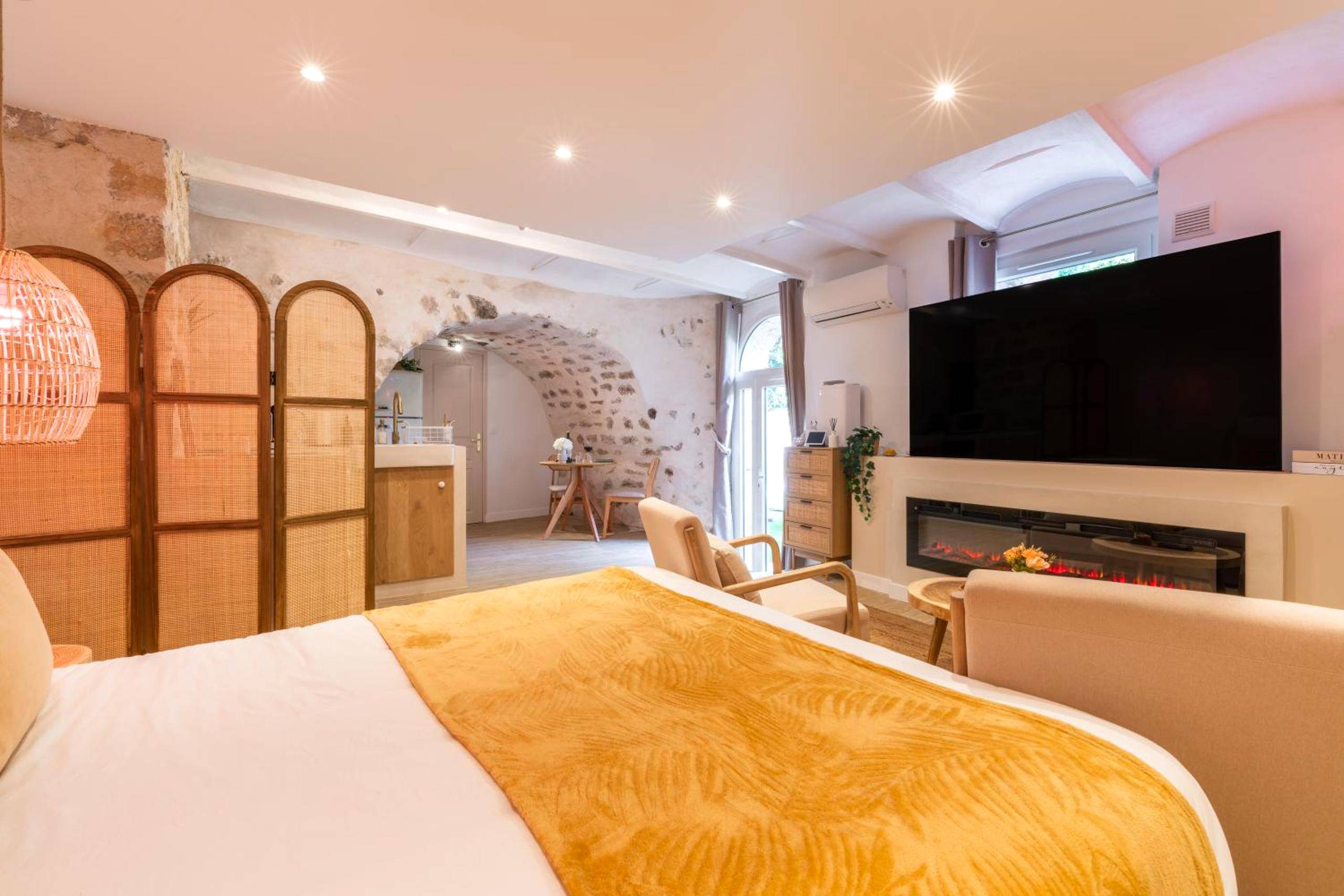 Espace nuit avec grand écran et cheminée - La Parenthèse Grassoise - Votre échappée romantique