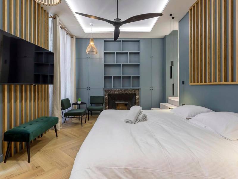 Chambre avec lit king size et cheminée décorative - Love Room Lyon - Love Room Balneo Sauna Pierre Corneille !