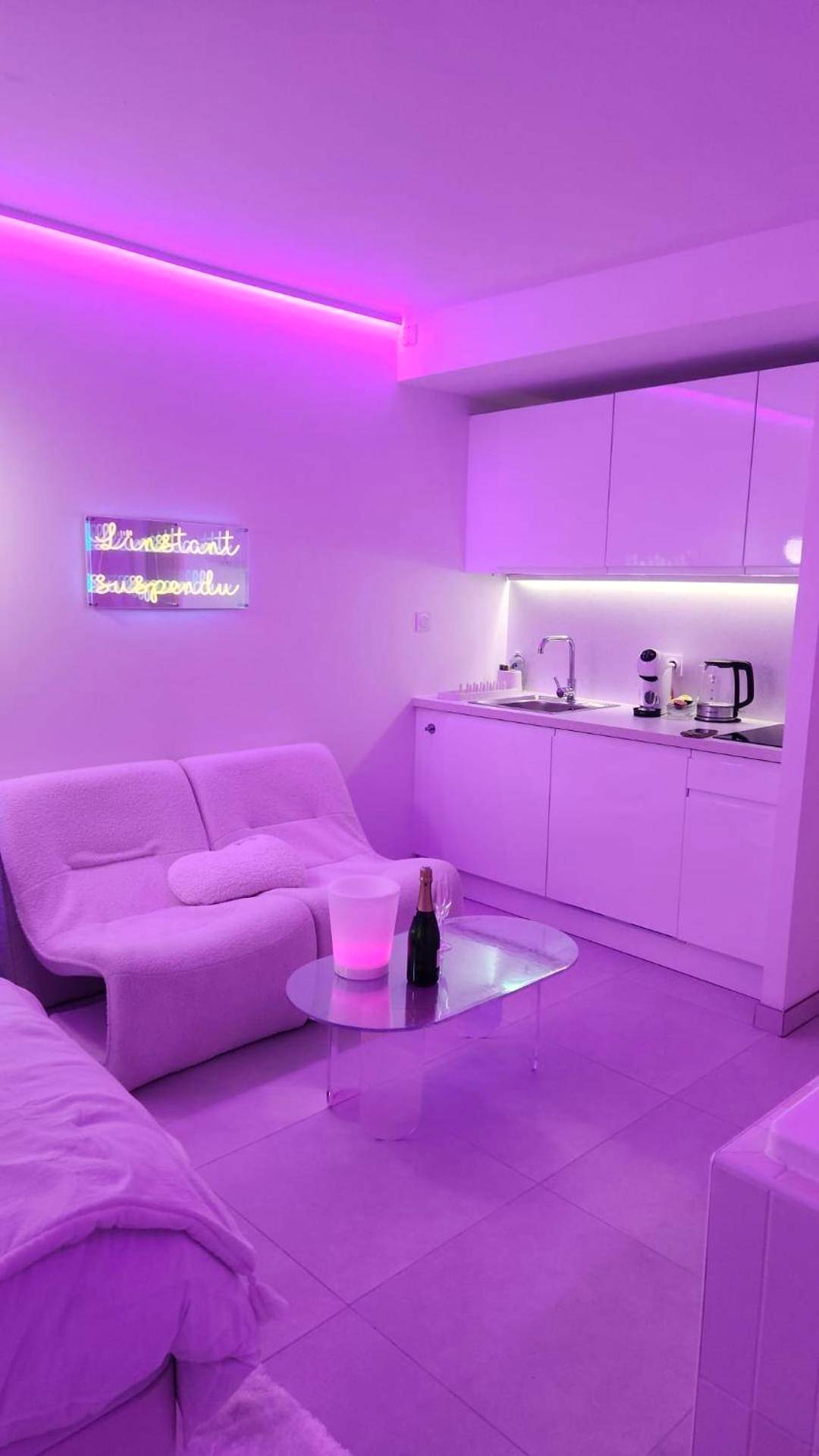 Salon et kitchenette avec éclairage LED rose - Love room à 30 mn des plages et de Vannes