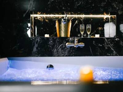 Détail du jacuzzi avec champagne et bougies - Promesse d'une nuit avec Balnéo privative