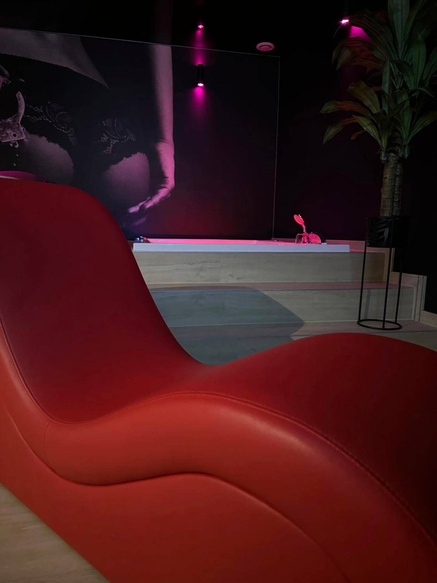 Fauteuil tantrique rouge devant le jacuzzi - L'Écrin de Saint - Red Room by Loveroomeo