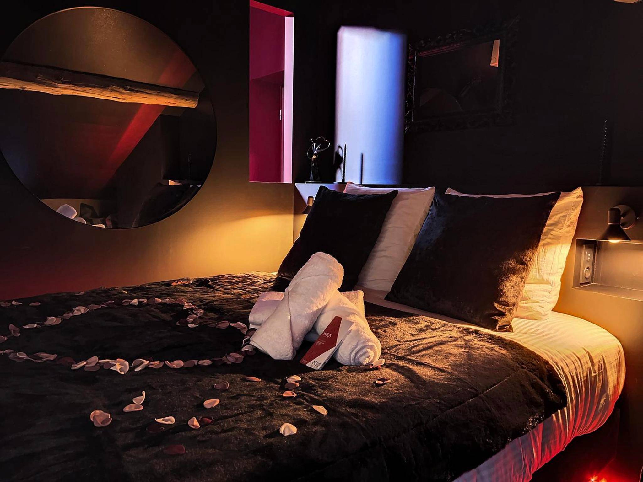 Lit double avec cœur en pétales et miroir rond - Suite Rouge baiser avec Jacuzzi privatif - LoveRoom Insolite