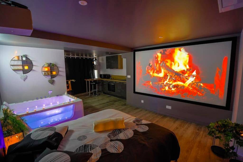 Espace nuit avec jacuzzi et feu de cheminée vidéo - Balnéo et Cinéma Le Saona