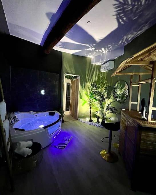Espace détente avec jacuzzi et bar en bois - la savane room