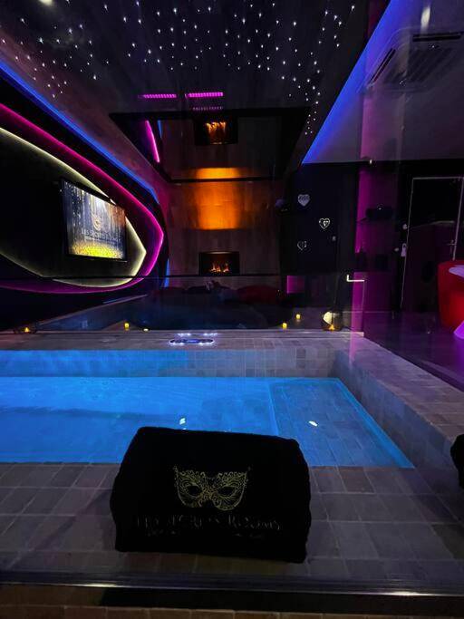 Jacuzzi privatif avec éclairage bleu et bougies - Les Secrets Rooms/Love Room