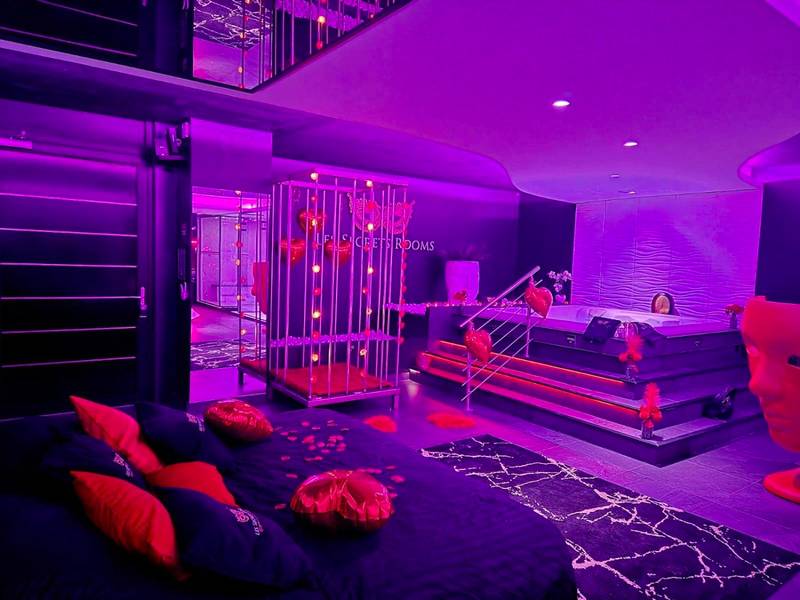 Lit king size avec pétales et ballons cœurs - Les Secrets Rooms