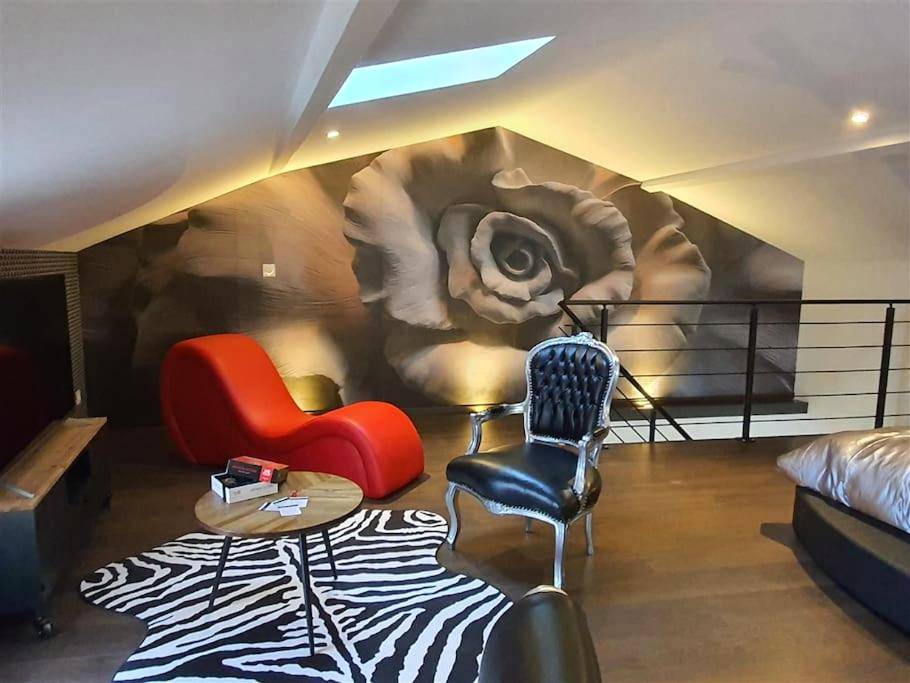 Salon avec fauteuil tantra et fresque rose - Love Room Ruelle - sur - Touvre - Love room avec spa privatif
