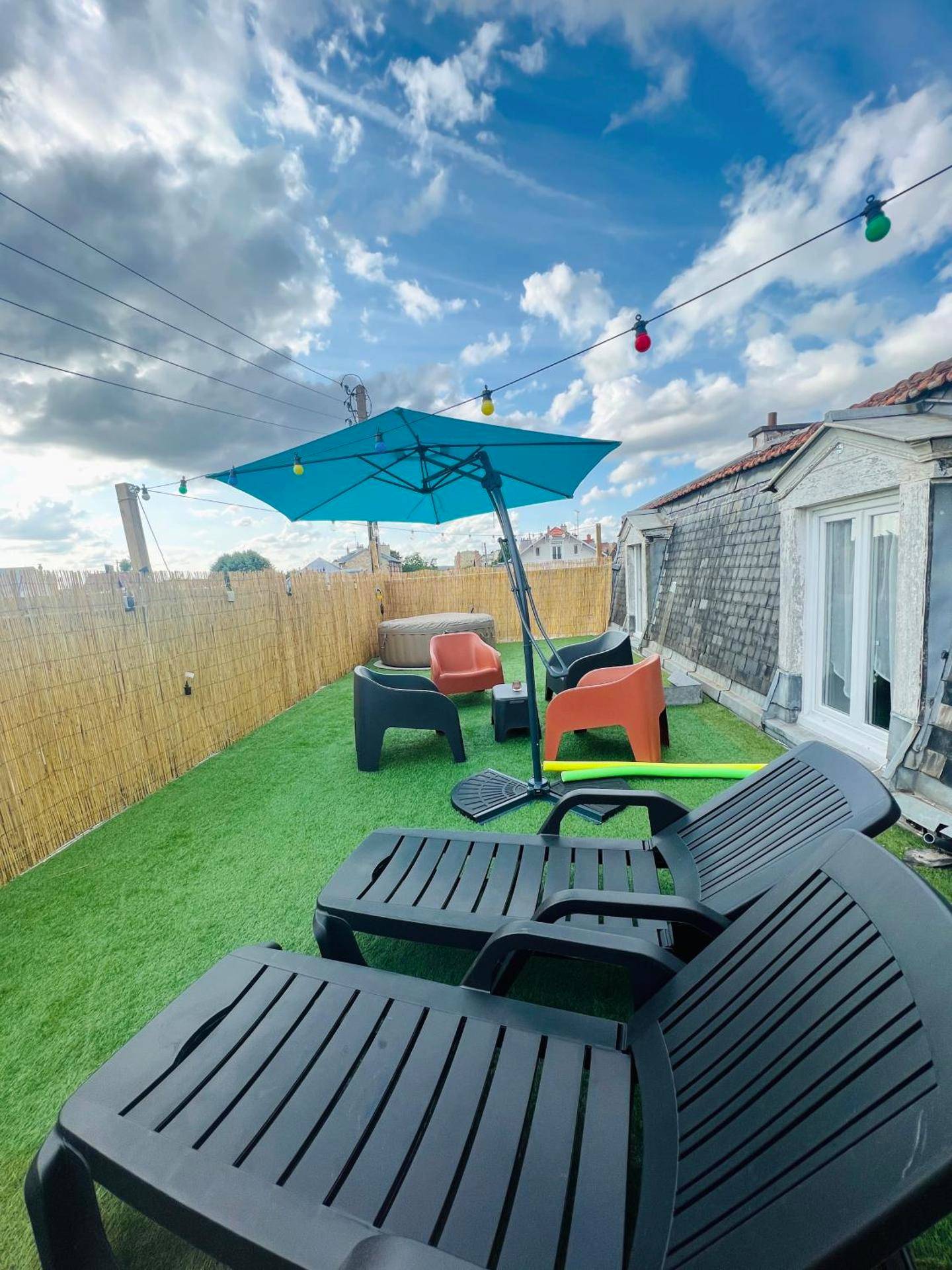 Terrasse aménagée avec transats et parasol - Love Room Appartement Spa Jacuzzi et Terrasse