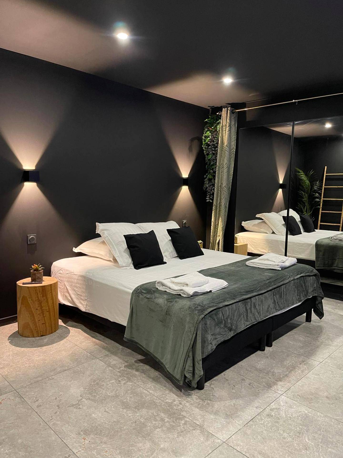 Chambre avec lit queen size et murs noirs - Love Room Clermont - Ferrand - Spa & Love Exotic - Balnéo - Sauna - Parking