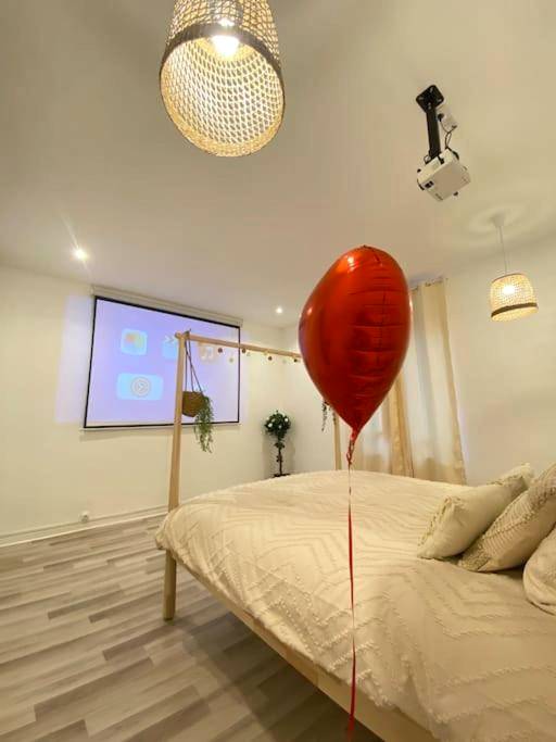 Lit king size face à un écran de projection - Appartement avec Spa et Sauna