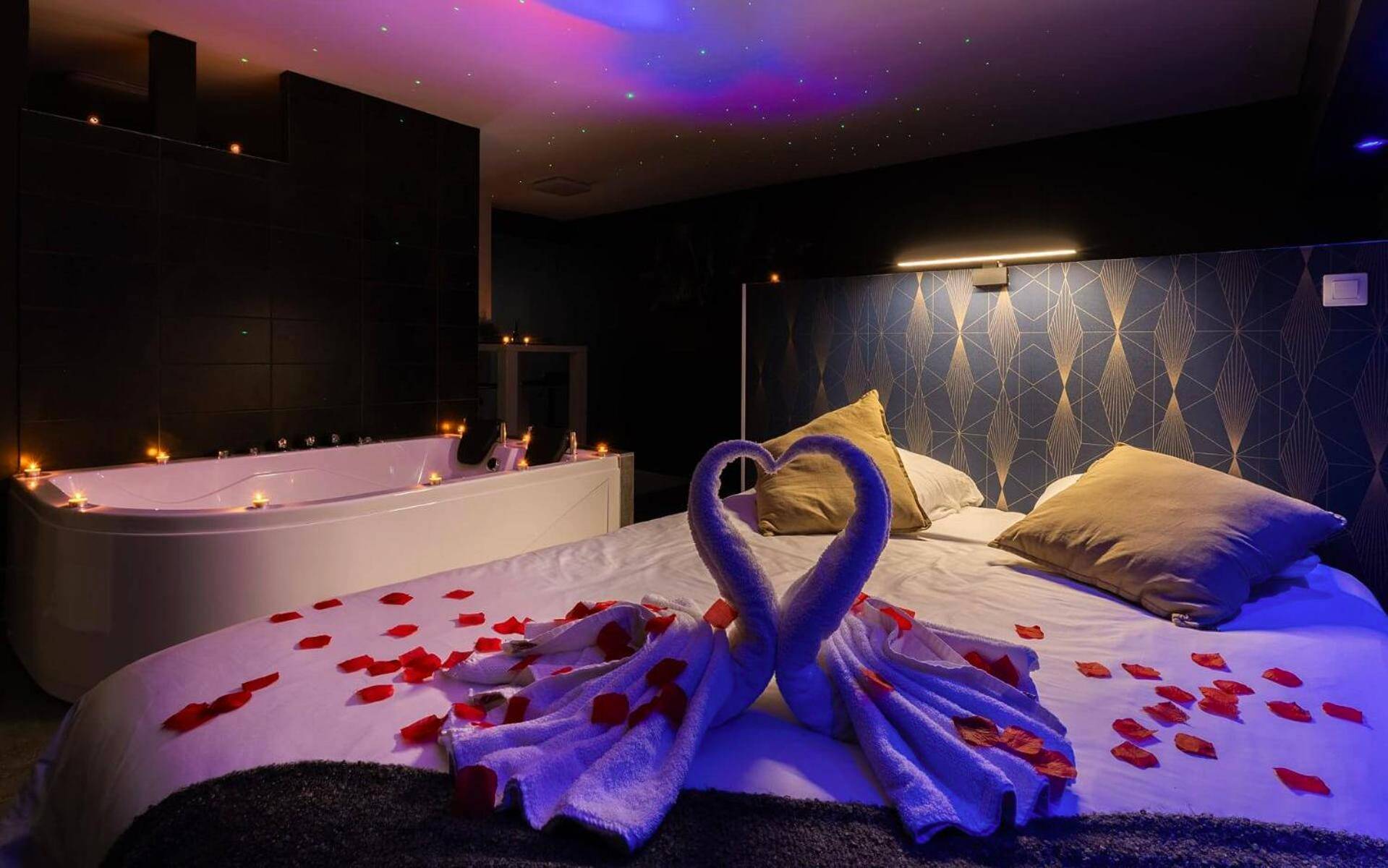 Lit avec cygnes en serviette et pétales de rose - Love Room Nancy - Suite Boréale 50m2 spa privatif.