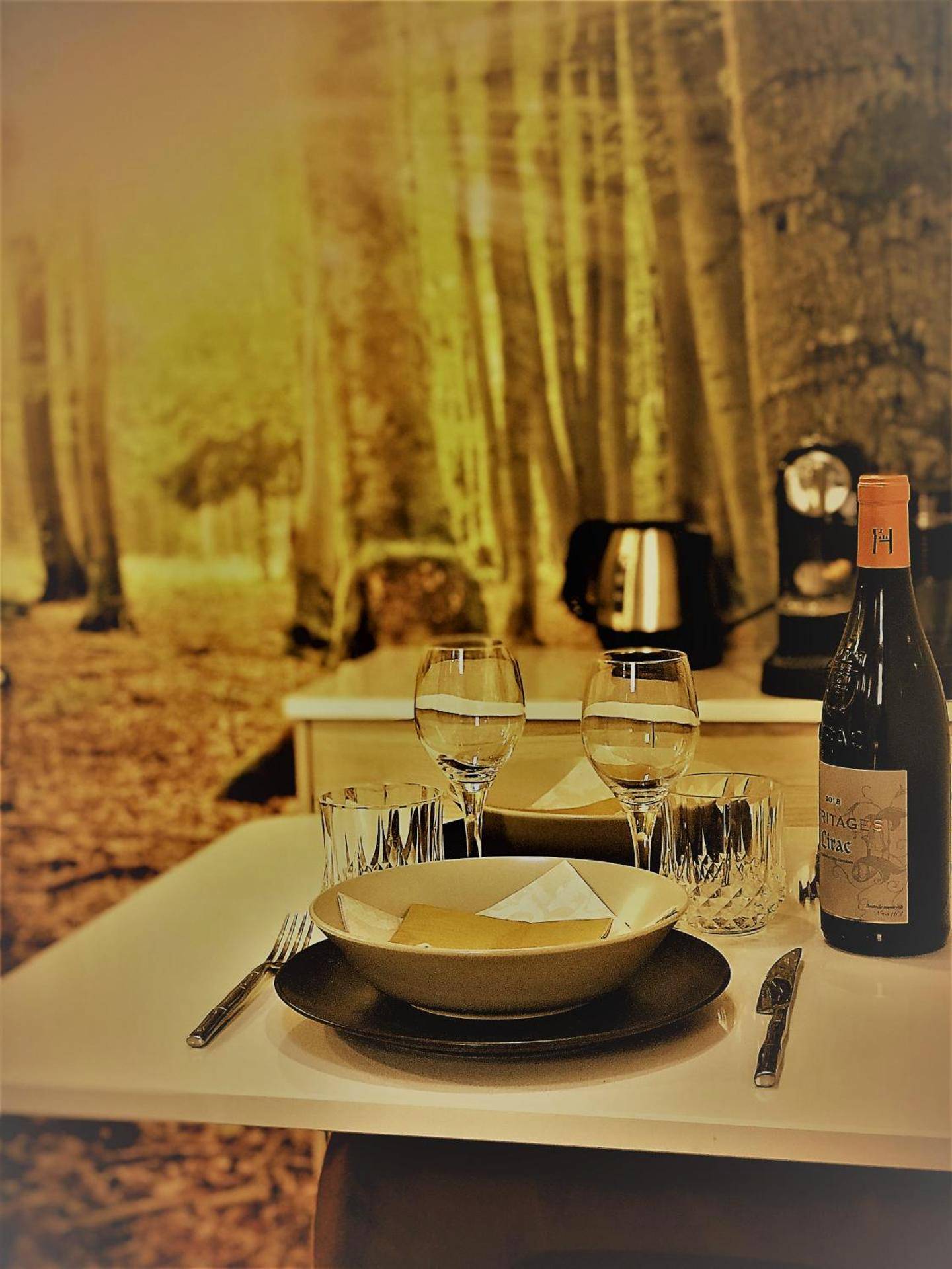 Table dressée pour deux avec bouteille de vin - Au Vingtain - Appartement & Spa atypique